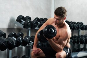 handsome young athlete working out gym