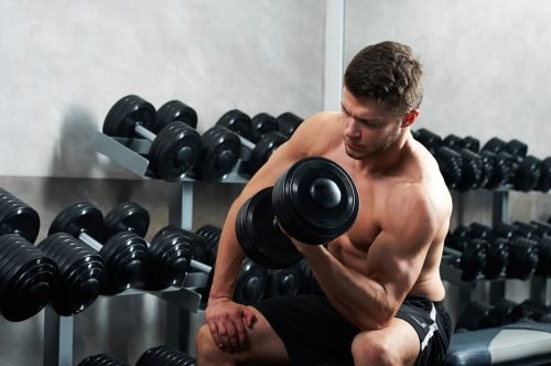 handsome young athlete working out gym